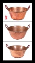 Three very large two-handled copper pans, the largest 68cm diameter (3)