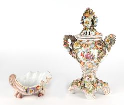 A continental flower encrusted two-handled urn & cover, 38cms high; together with a similar shell