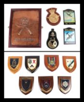 Twelve military wall shields and plaques including: Royal Ghurka Rifles, Royal Air Force, Battle