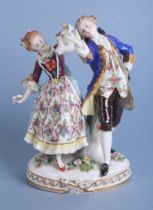 A continental porcelain group depicting a dancing couple, 23cms high. Condition Report The young