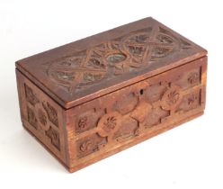 An 18th century style small carved pine box, 25cms wide.