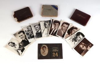 Three early to mid 20th century autograph albums; together with a quantity of black & white