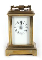 A brass four-pillar carriage clock, the white enamel dial with Roman numerals, 15cms high.