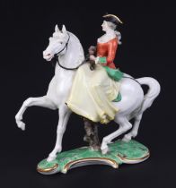 A Nymphenburg porcelain group depicting a lady wearing a tricorn hat riding a horse sidesaddle,