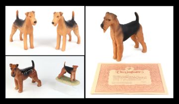 Two Beswick models of Airedale terriers, 14cms high; together with an Anne Godfrey limited edition