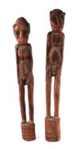 A pair of African carved hardwood male and female fertility figures, each approx 72cms high (2).