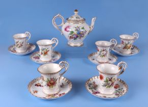 Six Dresden cups and saucers decorated with flowers, together with a similar Dresden teapot.