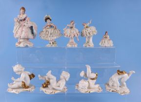 A group of continental crinoline lady figurines to include two Dresden examples, largest 16cm