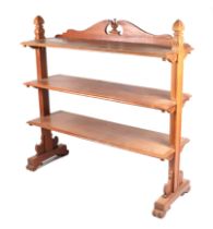 A Victorian walnut three-tier buffet with carved shaped end supports, 122cms wide.