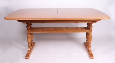 A blonde Ercol Dorchester Elm extending dining table with three extra leaves, 100cm by 222cm.