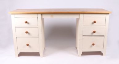 A modern painted twin pedestal desk with an arrangement of six drawers, 158cms wide; together with a