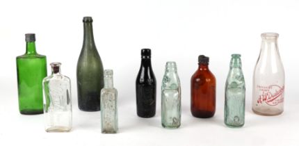 A small quantity of Victorian and later glass bottles M. Millard & Sons, Trowbridge Codswallop