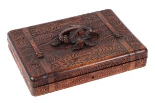 A Black Forest carved wooden games compendium incorporating dominoes, cribbage board, dice, counters
