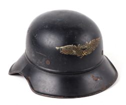 A WWII German Luftschutz steel helmet, with winged decal to the front centre, having leather liner