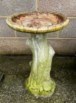 A well weathered stoneware bird bath, 60cm high.