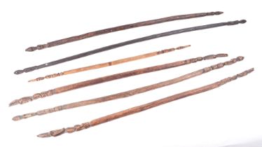 A group of six African ceremonial dance wands, with figural terminals, largest 119cm long (6).