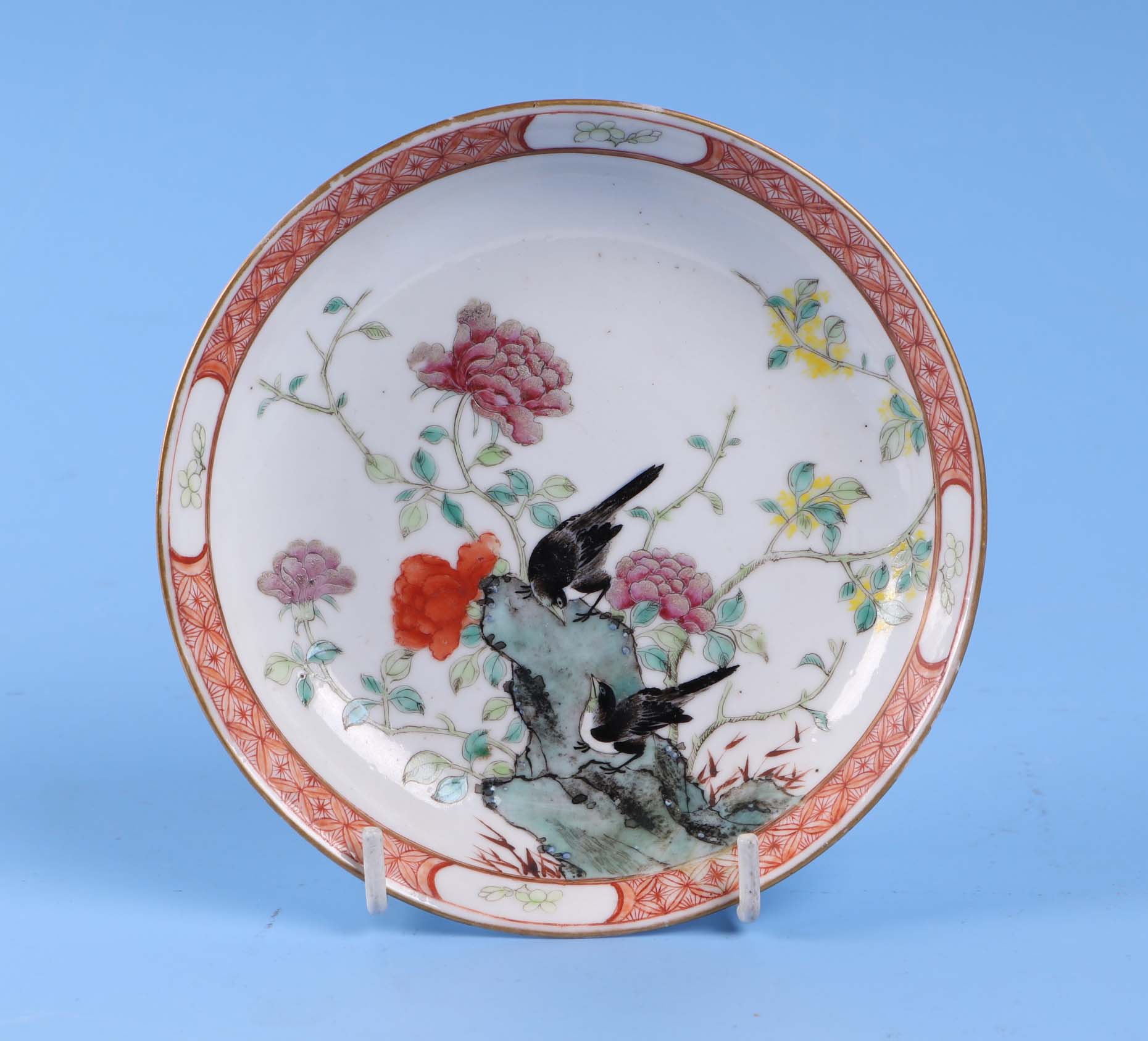 An 19th century Chinese famille rose small shallow dish decorated with magpies and prunus flowers,