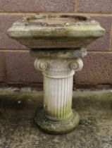 A well weathered stoneware bird bath, 50cm high.