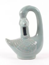 A Chinese celadon glazed water dropper, in the form of a goose holding a fish, 18cm high.