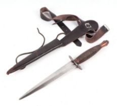 A Commando knife in its leather leg scabbard. with cross keys makers mark to hilt. Blade length 16.