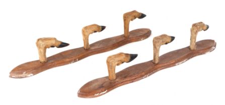 A wall hanging Deer's Foot gun rack in two parts to hold three shotguns / riding crops. Overall
