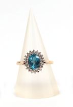 A 9ct gold cluster ring, set with a large oval turquoise coloured stone surrounded by diamonds,