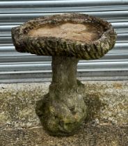 A well weathered stoneware bird bath, the column with playing foxes, 54cm high.