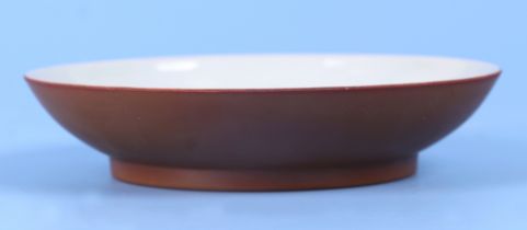 A Chinese café au lait saucer dish with six character blue mark to the underside, 15cm diameter.