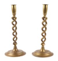 A pair of brass candlesticks, with open twist columns, 30cm high.