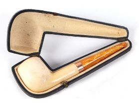 A cased pipe, with amber type mouth piece and 9ct gold collar, 14cm long.