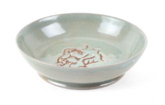 A Chinese crackleware celadon shallow bowl, with incised decoration, 14cm diameter.