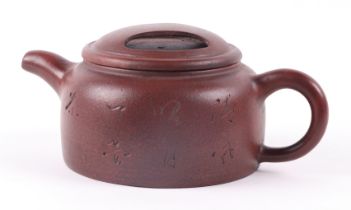 A Chinese Yixing pottery teapot, decorated with calligraphy, with impressed seal mark to the