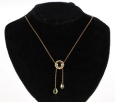 A 9ct gold Peridot and pearl pendant drop necklace, the central Peridot surrounded by pearls with