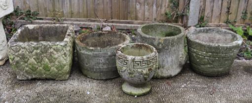 A group of five well weathered stoneware planters.