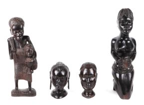 An African Tribal carved hardwood fertility figure of a woman holding a baby, 37cm high, a women