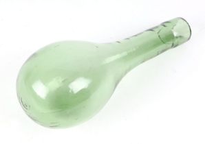 An 18th century hand blown green glass water bottle, 19cm long.