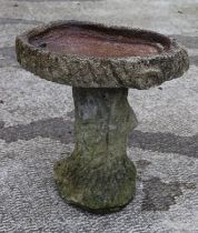 A well weathered bird bath, 44cm high,