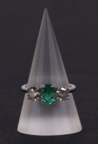 A certificated 18ct white gold, emerald and diamond trilogy ring, emerald approx 0.66ct, diamond