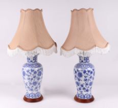 A pair of Chinese blue and white baluster form table lamps on wooden bases, 70cm high including