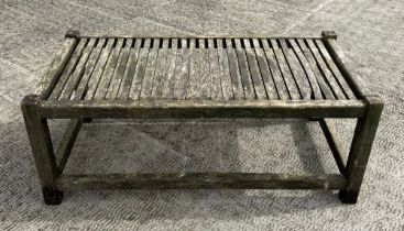 A well weathered teak garden coffee table, 98cm wide.