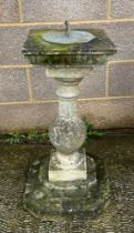 A well weathered stoneware garden sun dial, 72cm high.