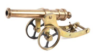 A cast brass cannon on carriage, with 20cm long barrel.