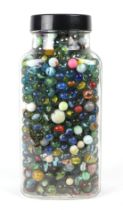 A large quantity of vintage marbles, in a glass jar.