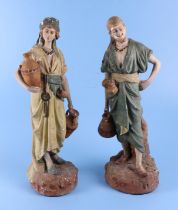 A pair of late 19th / early 20th century plaster figures of water sellers, each 51cm high.