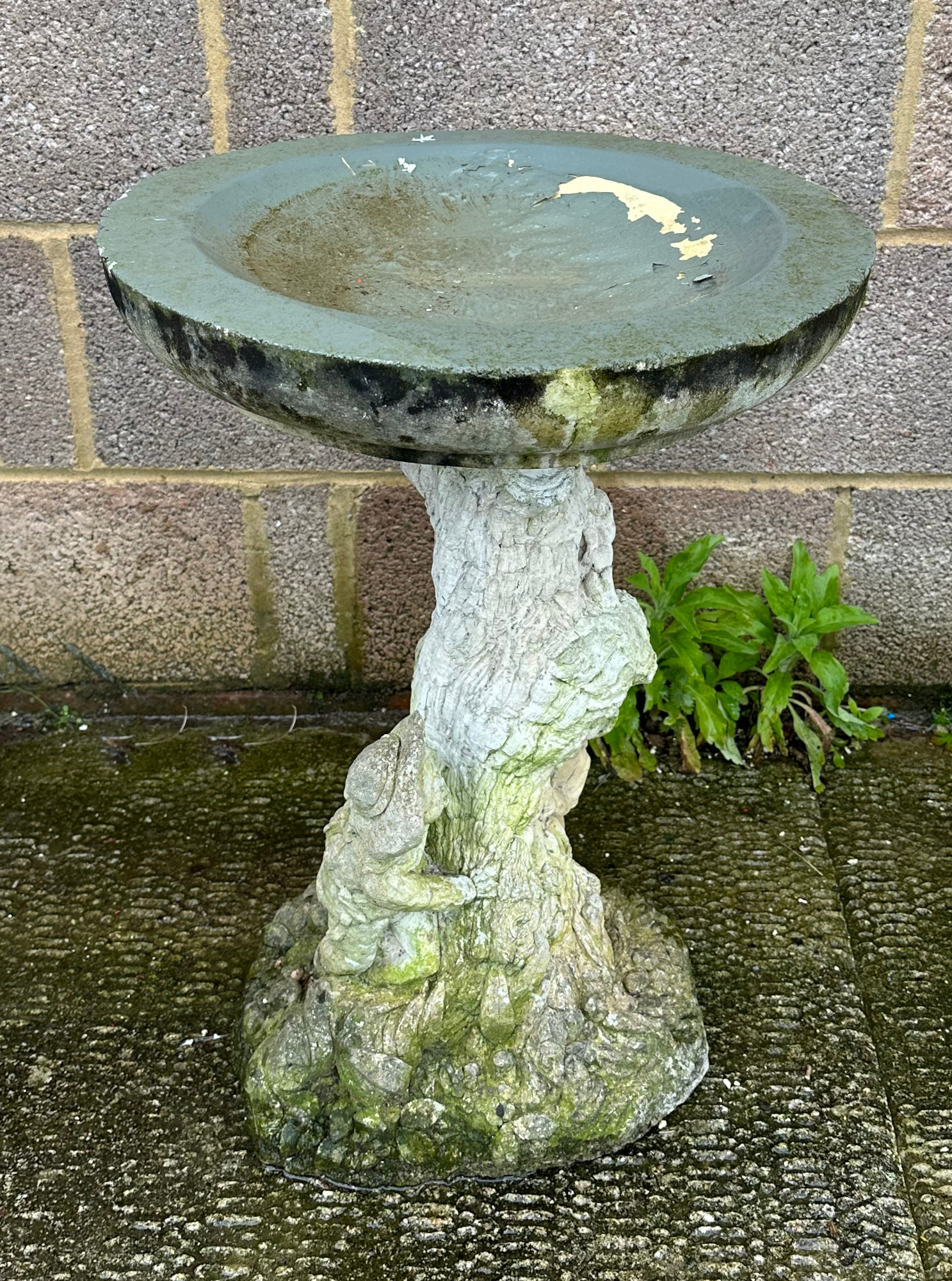 A well weathered stoneware bird bath, 61cm high.