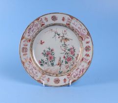 An 18th century Chinese famille rose plate decorated with birds, insects and flowers, 23cm diameter,