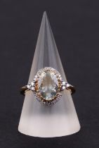 A 14ct gold oval aquamarine and diamond cluster ring, aquamarine approx 2.01ct, approx UK size O.
