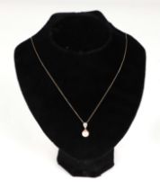 A 9ct gold cultured pearl and diamond pendant, on a fine chain.