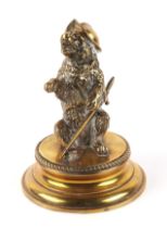 A 19th century brass inkwell, modelled as a bear wearing a helmet and sword, 19cm high.