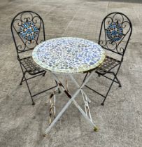 A mosaic top folding garden table, with two matching chairs, table 60cm diameter (3).